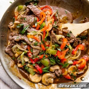 overhead wide shot of a skillet with stir fried beef and vegetables