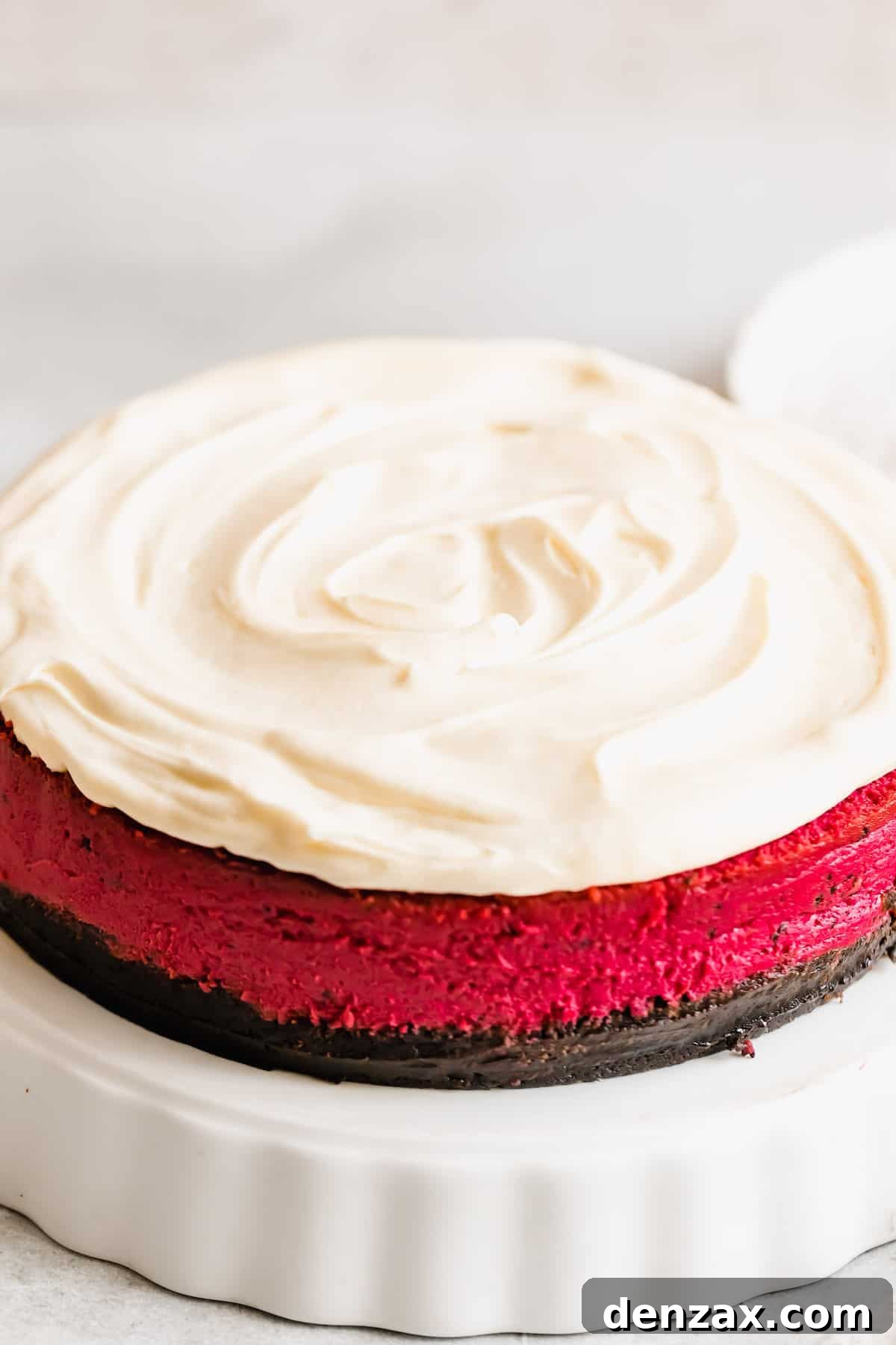 A Close-Up Shot of a Red Velvet Cheesecake Frosted with Homemade Cream Cheese Icing