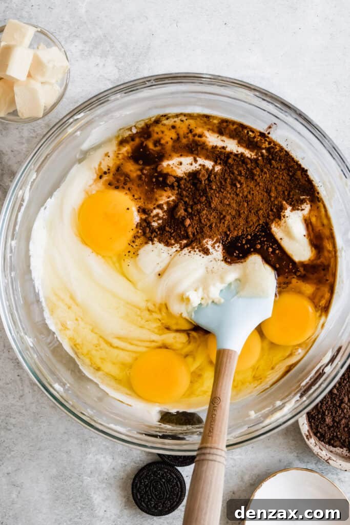 Cheesecake Batter Ingredients Being Mixed Together with a Rubber Spatula