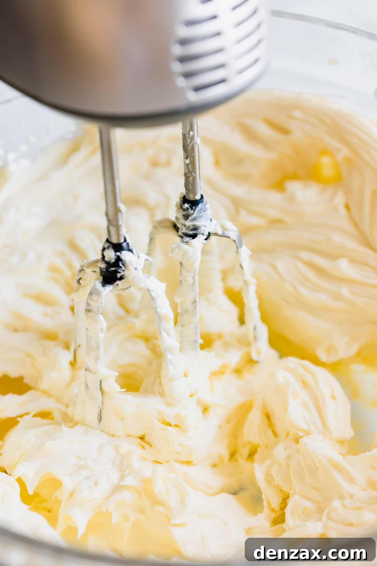 Cream Cheese Frosting Being Beaten with an Electric Stand Mixer