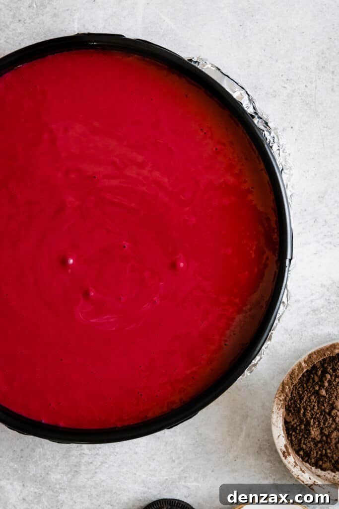 Bright Red Velvet Cheesecake Batter in a Springform Pan