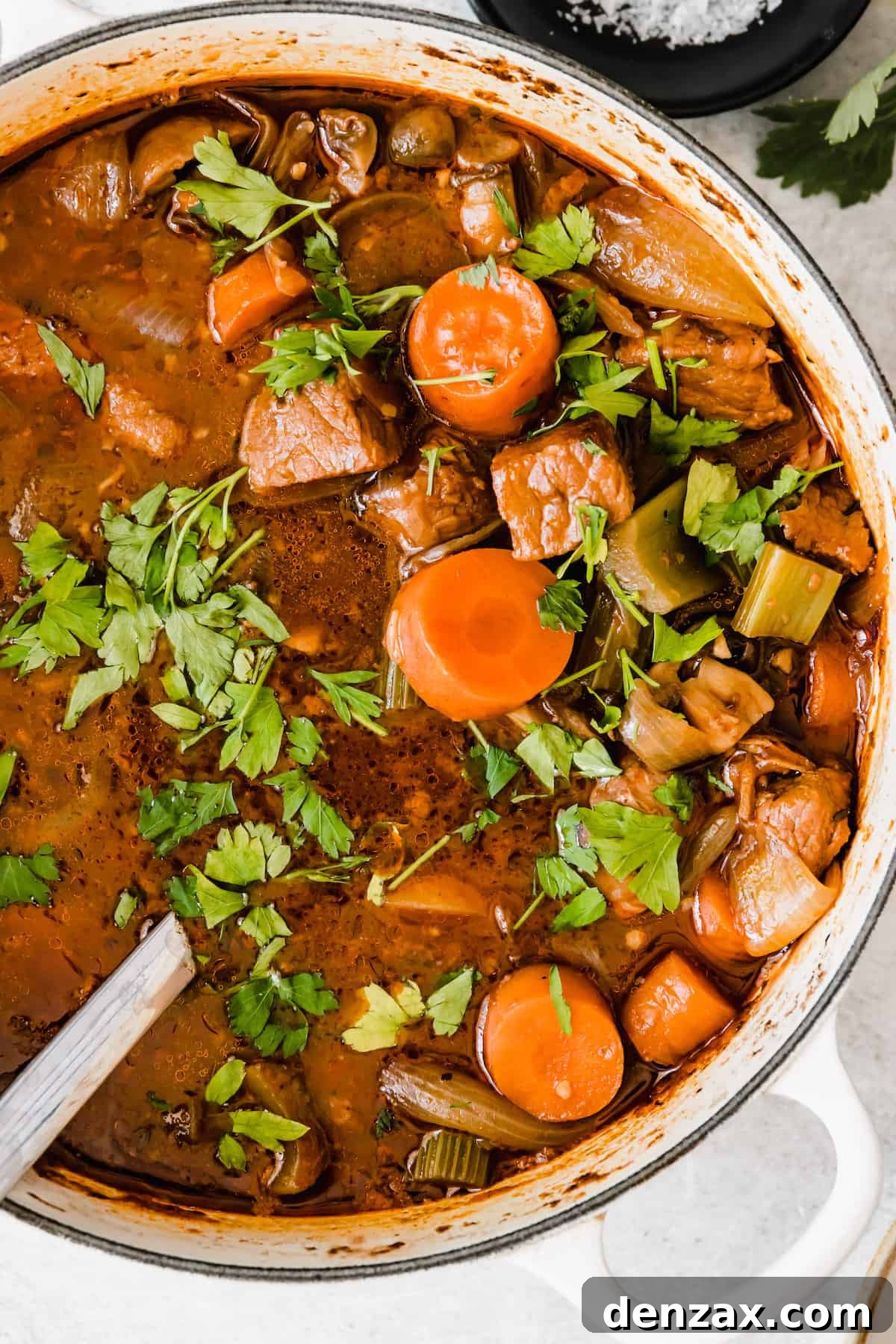 Rich Guinness Beef Stew Recipe for Comforting Dinner 2 overhead close up shot of beef stew in a white dutch oven