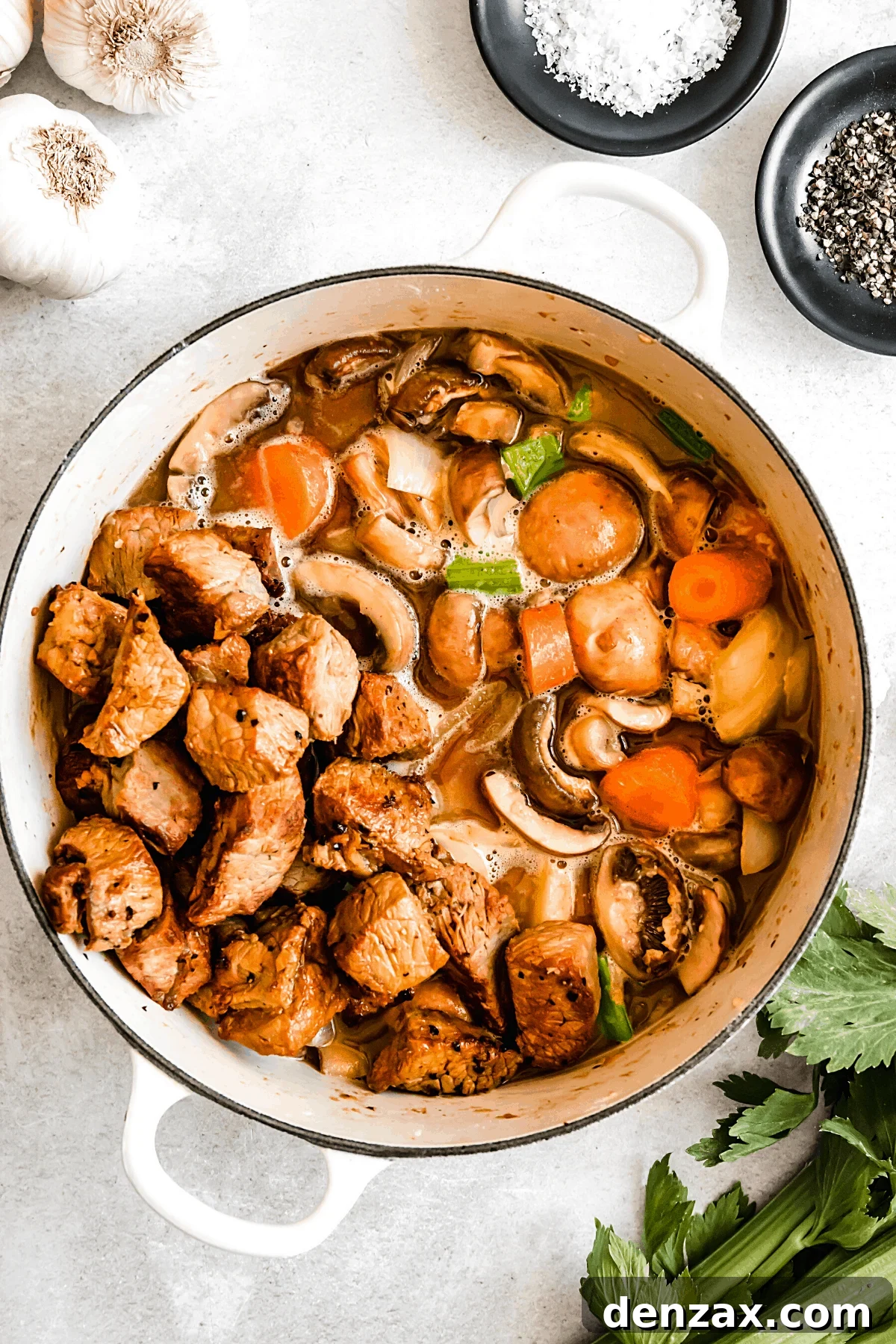 Rich Guinness Beef Stew Recipe for Comforting Dinner 8 overhead shot of guinness beef stew in a white dutch oven