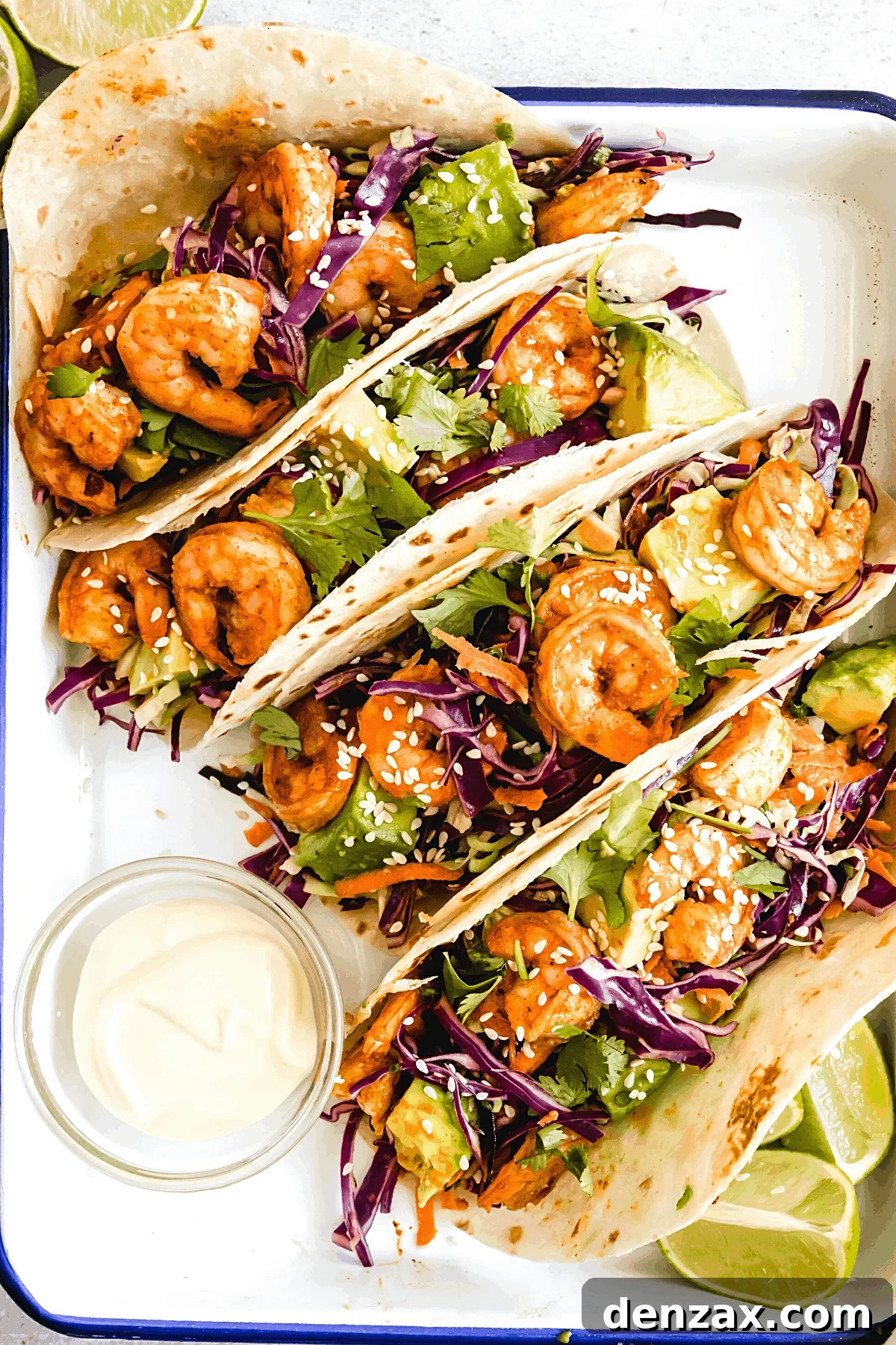 Four Shrimp Tacos Topped with Asian Slaw on a Serving Platter