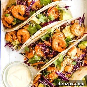 Four Shrimp Tacos Topped with Asian Slaw on a Serving Platter