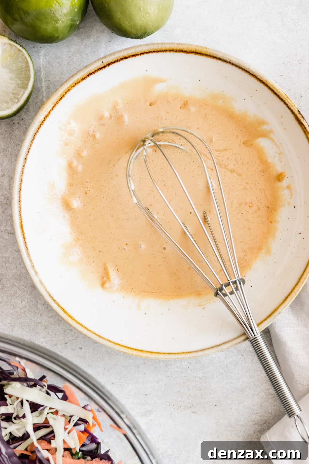 Asian Dressing in a White Bowl with a Whisk