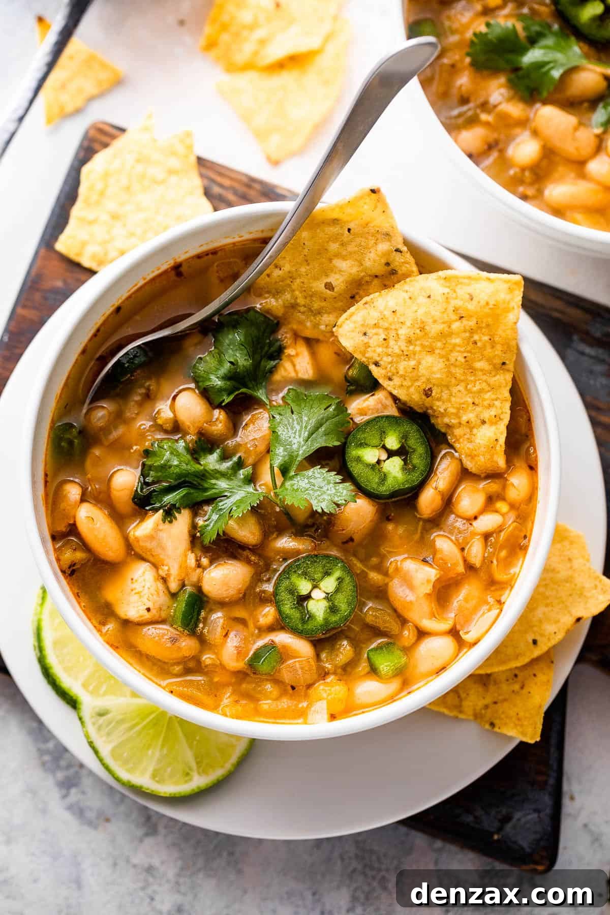 overhead shot of white soup bowls with chicken chili