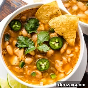 overhead shot of white soup bowls with chicken chili