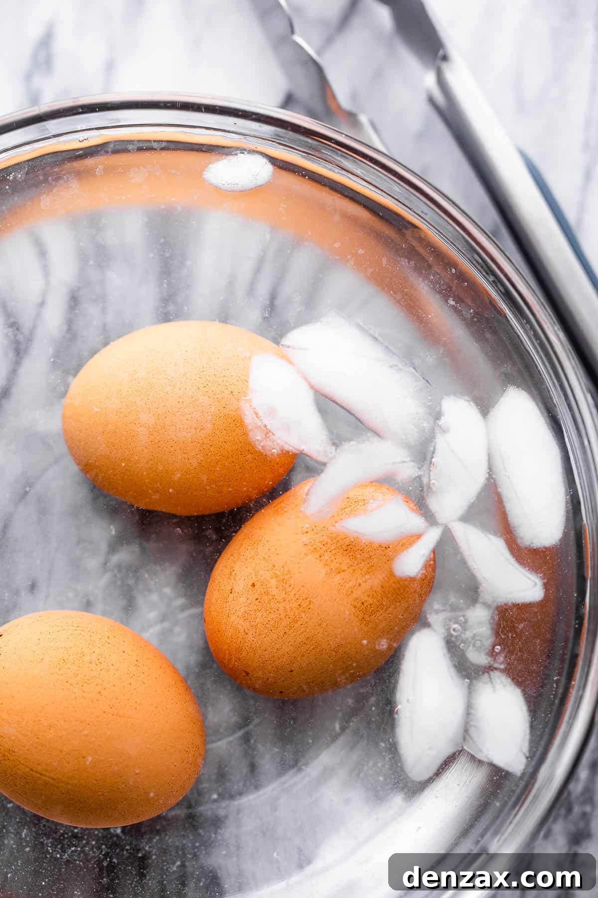 brown eggs cooling in ice bath
