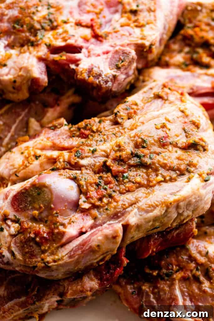 raw shoulder lamb chops topped with sundried tomatoes marinade