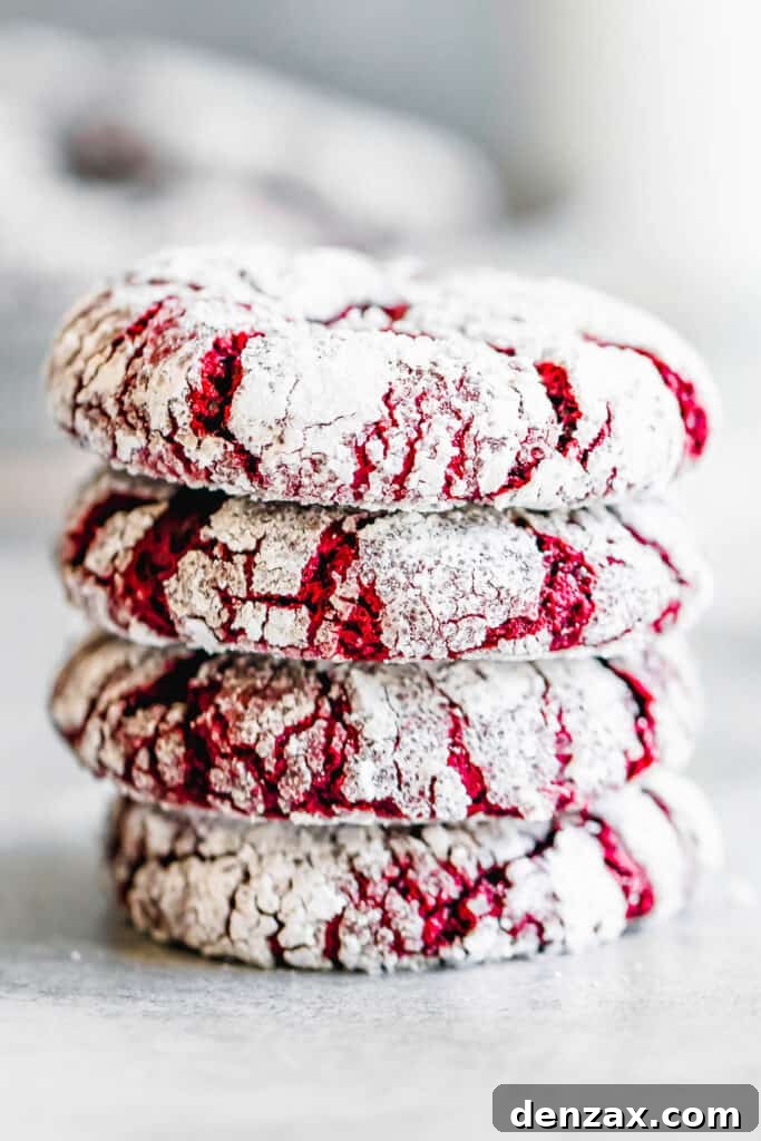 Four Crinkle Cookies Stacked on a Smooth White Surface
