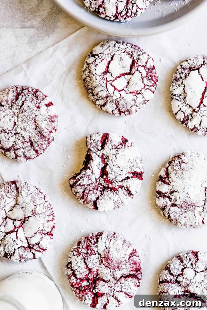 Red Velvet Crinkle Cookies Arranged on a White Placemat, Seen From Above