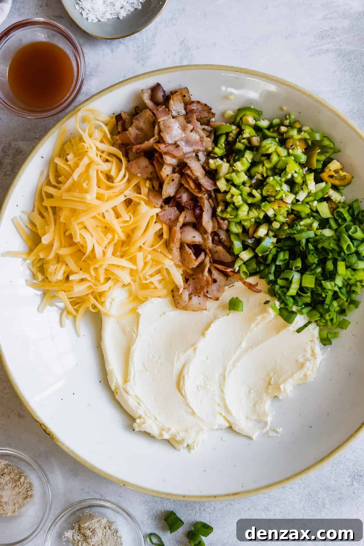 Sour Cream, Shredded Cheese, Bacon Bits and Scallions in a Bowl