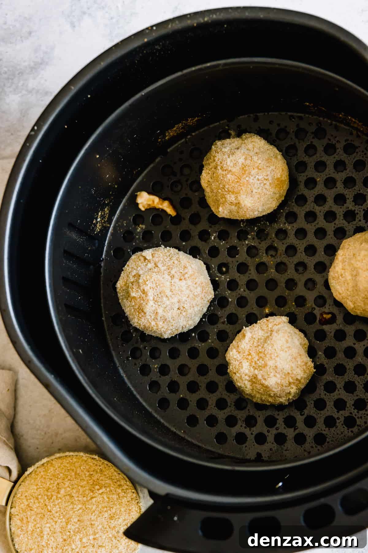 Four Jalapeno Popper Balls in an Air Fryer Basket