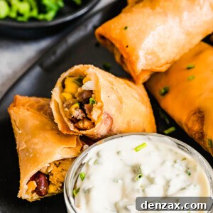 A Plate of Egg Rolls with a Glass Dish of Dipping Sauce