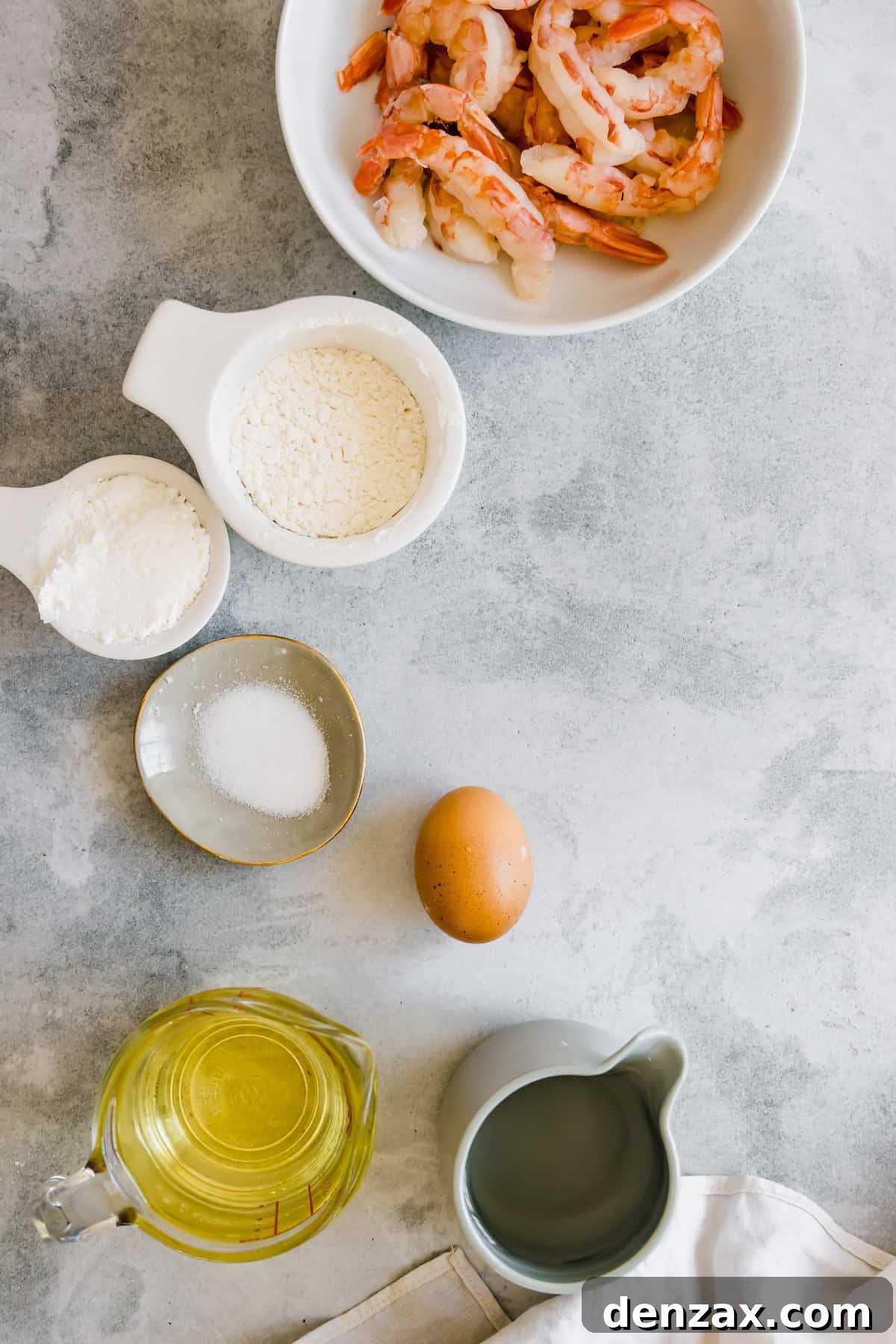 Oil, an Egg, Cornstarch, Salt and the Rest of the Shrimp Tempura Ingredients on a Countertop