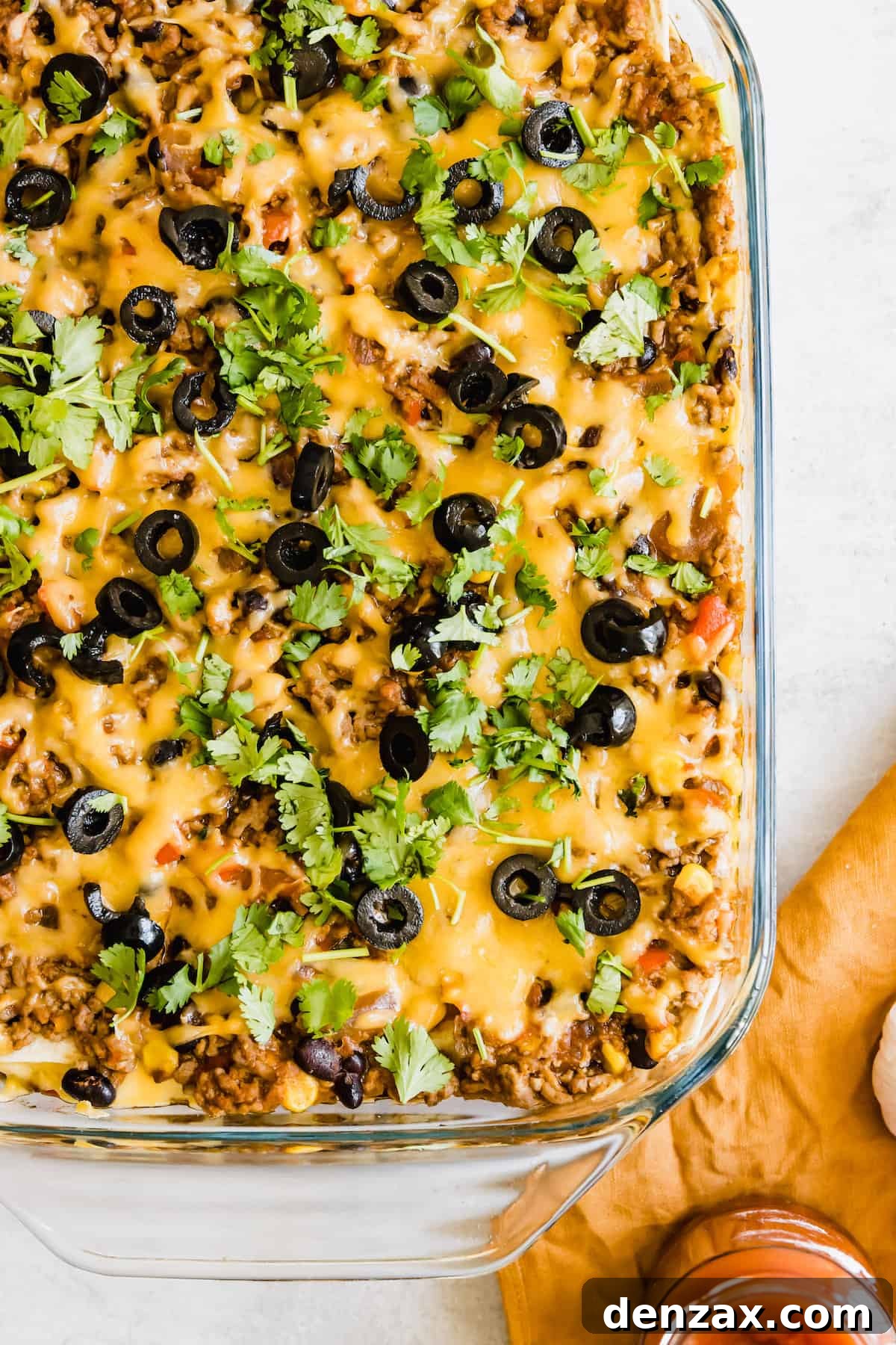 A Glass Casserole Dish Filled with Mexican Lasagna on a Countertop