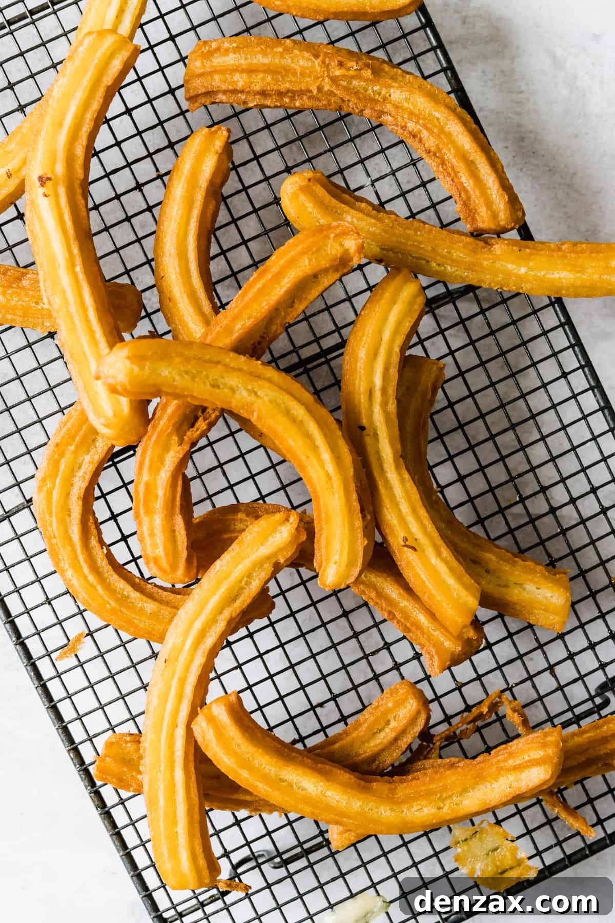 Sixteen Churros on a Wire Cooling Rack