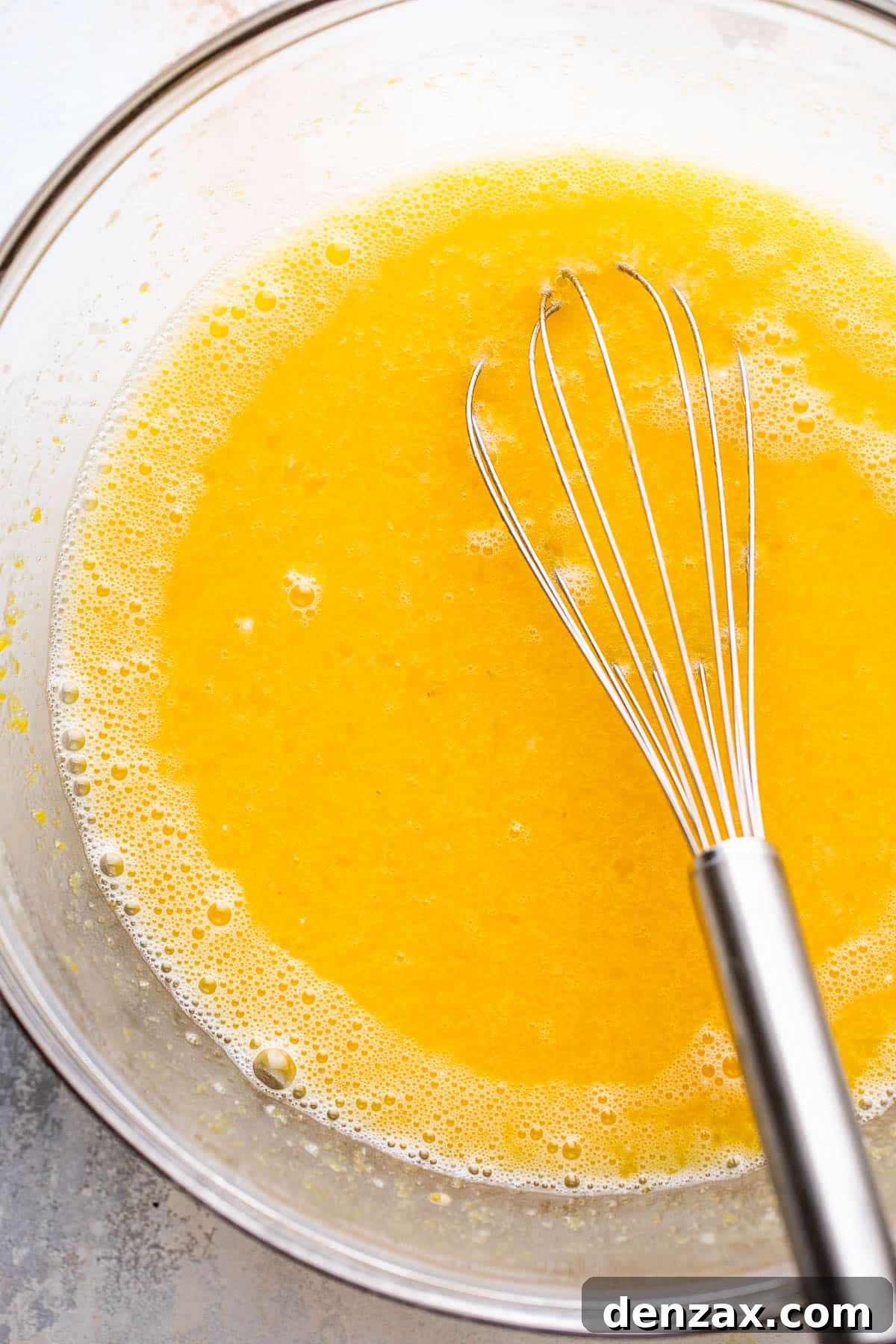 mixing bowl filled with egg and lemon juice batter for lemon bars