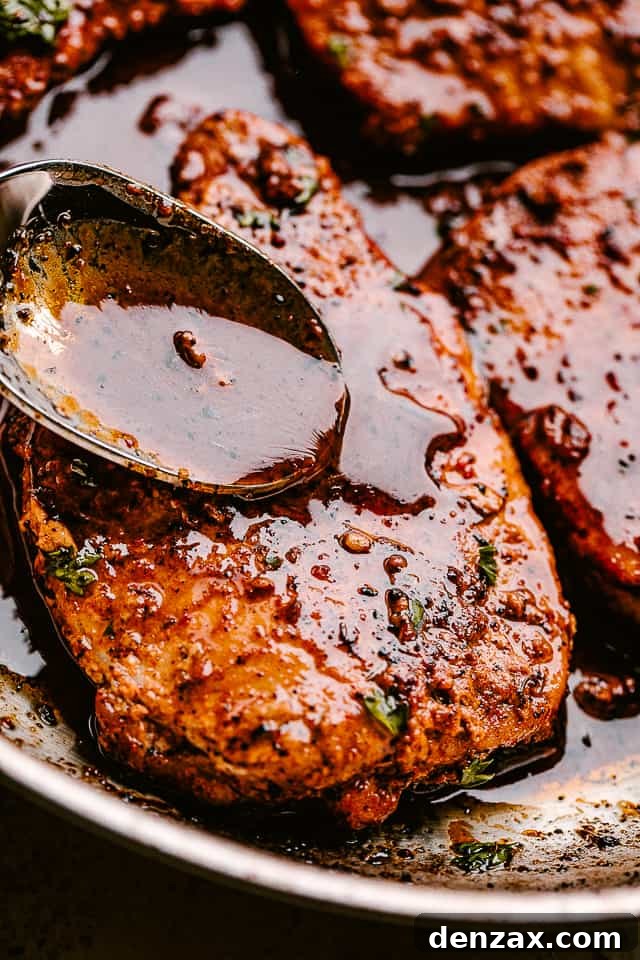 Spooning sauce over pan fried pork chops