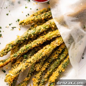 overhead shot of baked parmesan panko asparagus fries served with ketchup on the side