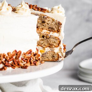 A Slice of Frosted Layer Cake Being Lifted From a Cake Stand