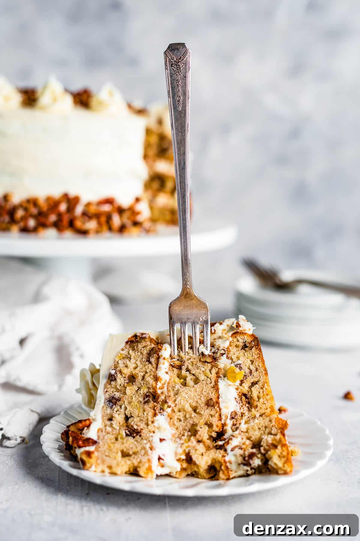 A Piece of Hummingbird Cake with a Metal Fork Stuck Into it