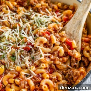 American Goulash Being Mixed in a Pot with a Wooden Spoon