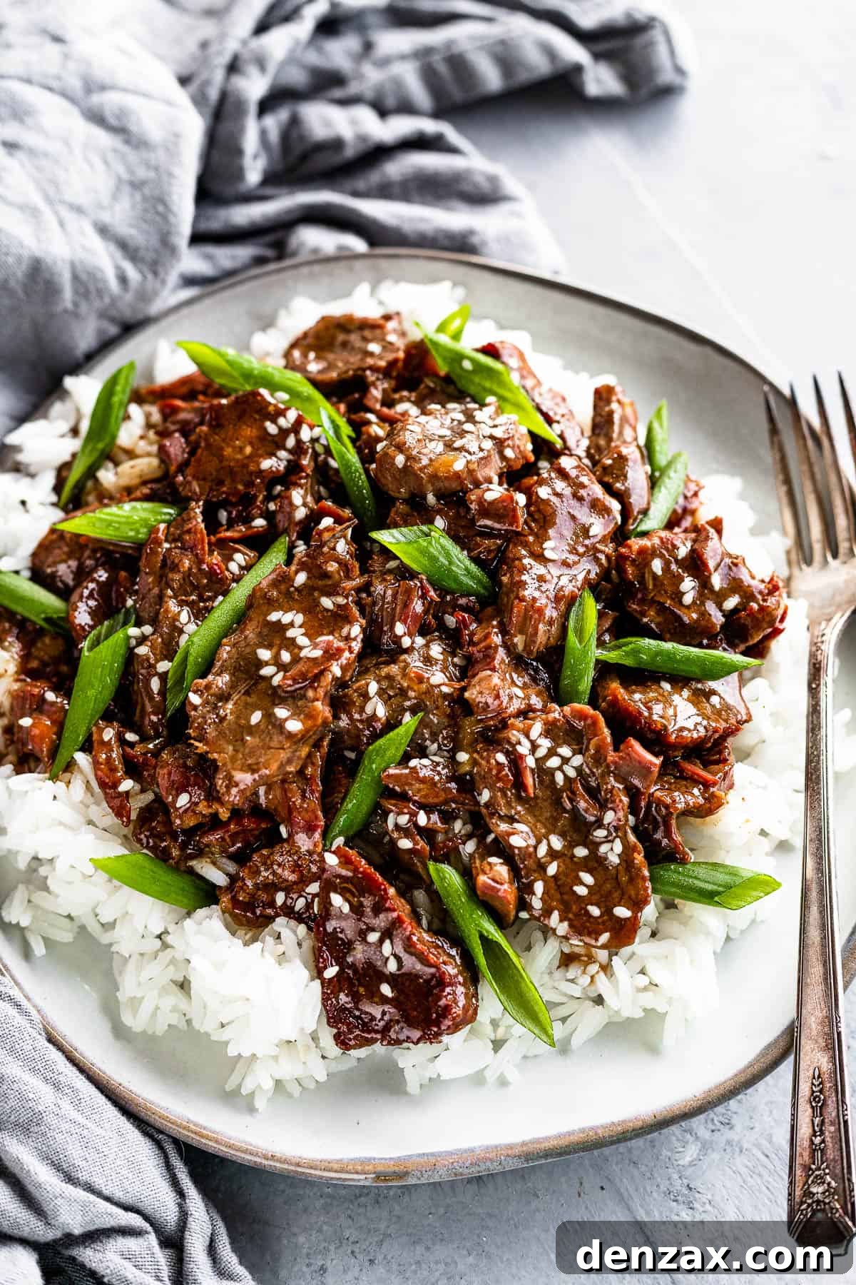 A Plate of Instant Pot Mongolian Beef with Green Onions over Rice