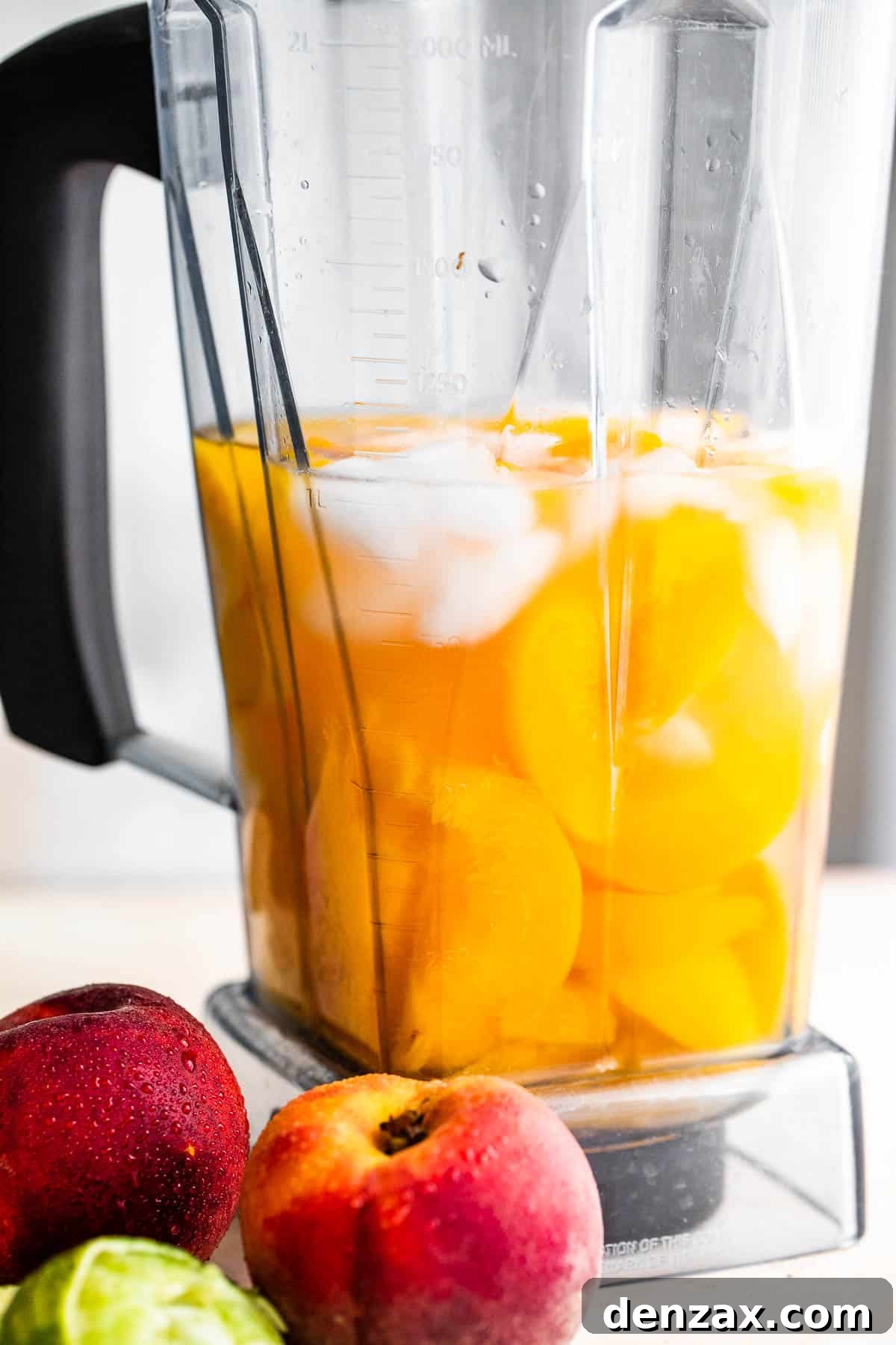 fresh peaches, rum, and ice in a blender