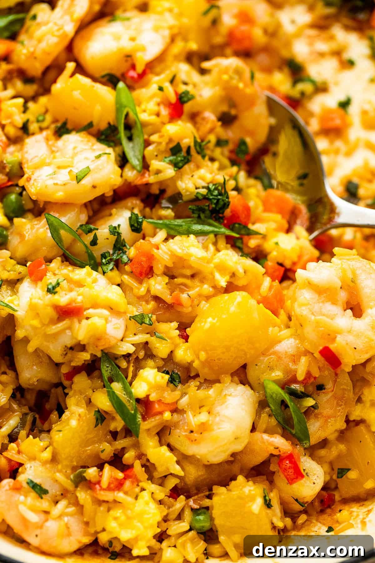 scooping out Shrimp Fried Rice with a large stainless spoon