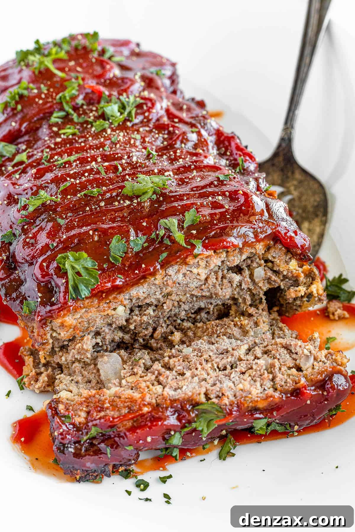 A Plate Full of Meatloaf with One Slice Removed