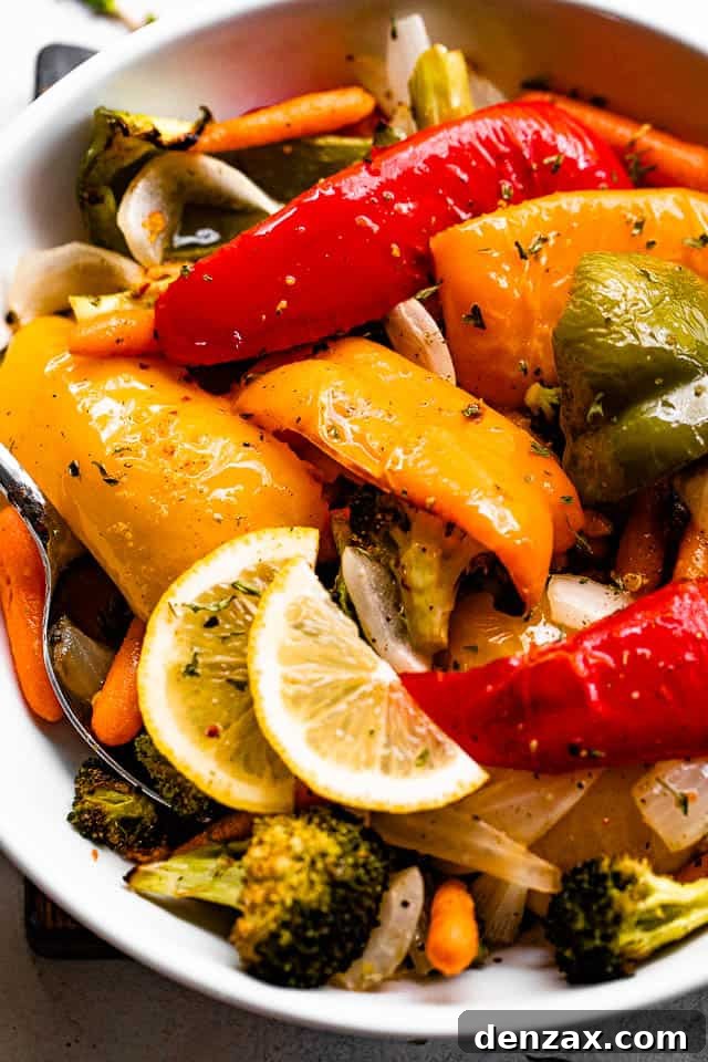 Lemon-Dressed Grilled Vegetables Recipe for Summer Sides 2 grilled vegetables served in a white bowl and garnished with lemon slices