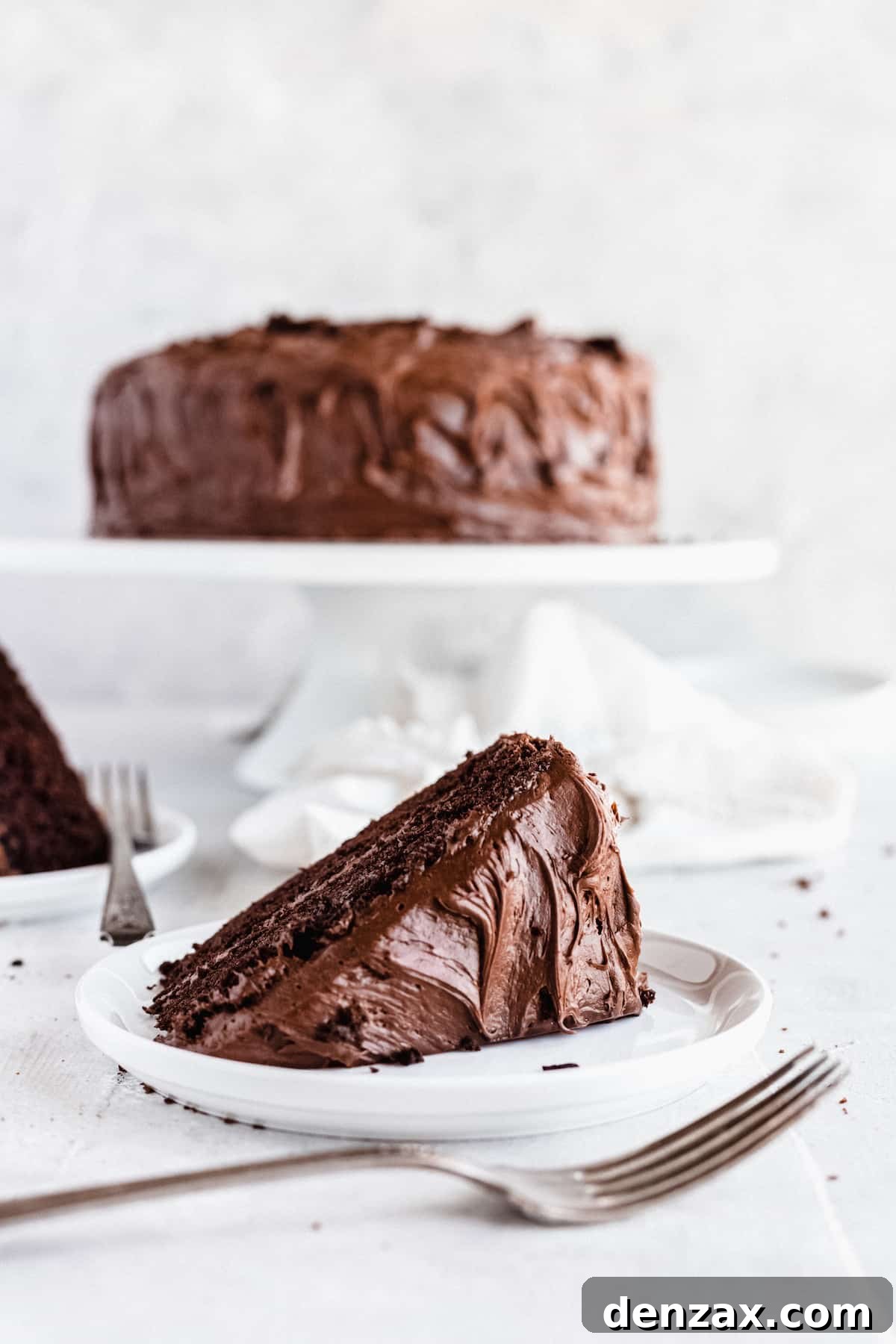 A Sideways-Lying Slice of Chocolate Cake on a Countertop with a Fork
