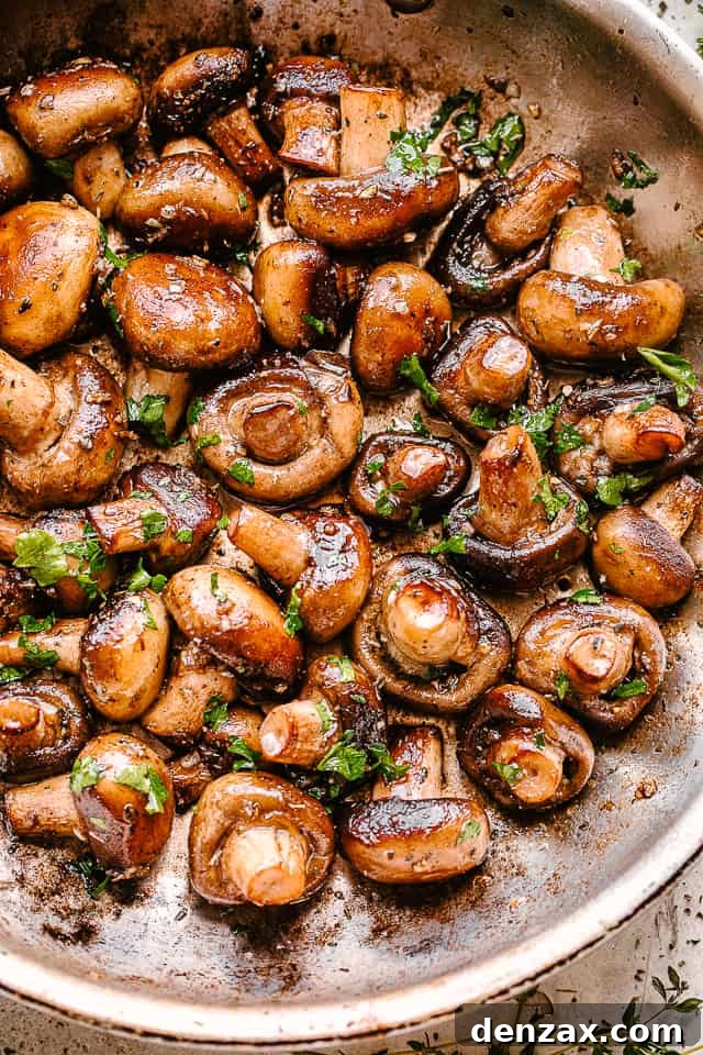 Garlic butter mushrooms in a skillet.