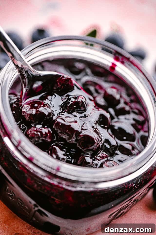 Close up of a jar of homemade blueberry sauce.