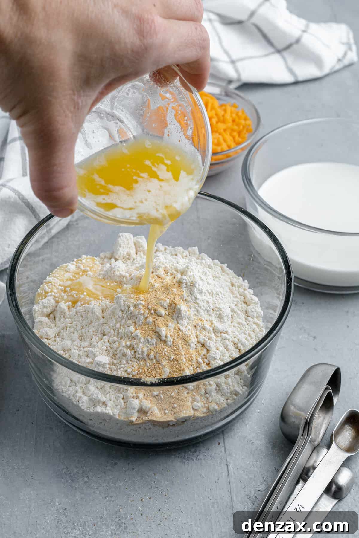 Melted Butter Being Poured Over a Bowl of Bisquick Mix