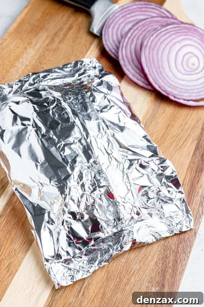 Foil-Wrapped Cheeseburgers with Roasted Veggies & Potatoes 4 Folded foil on a cutting board and stuffed with cheeseburgers