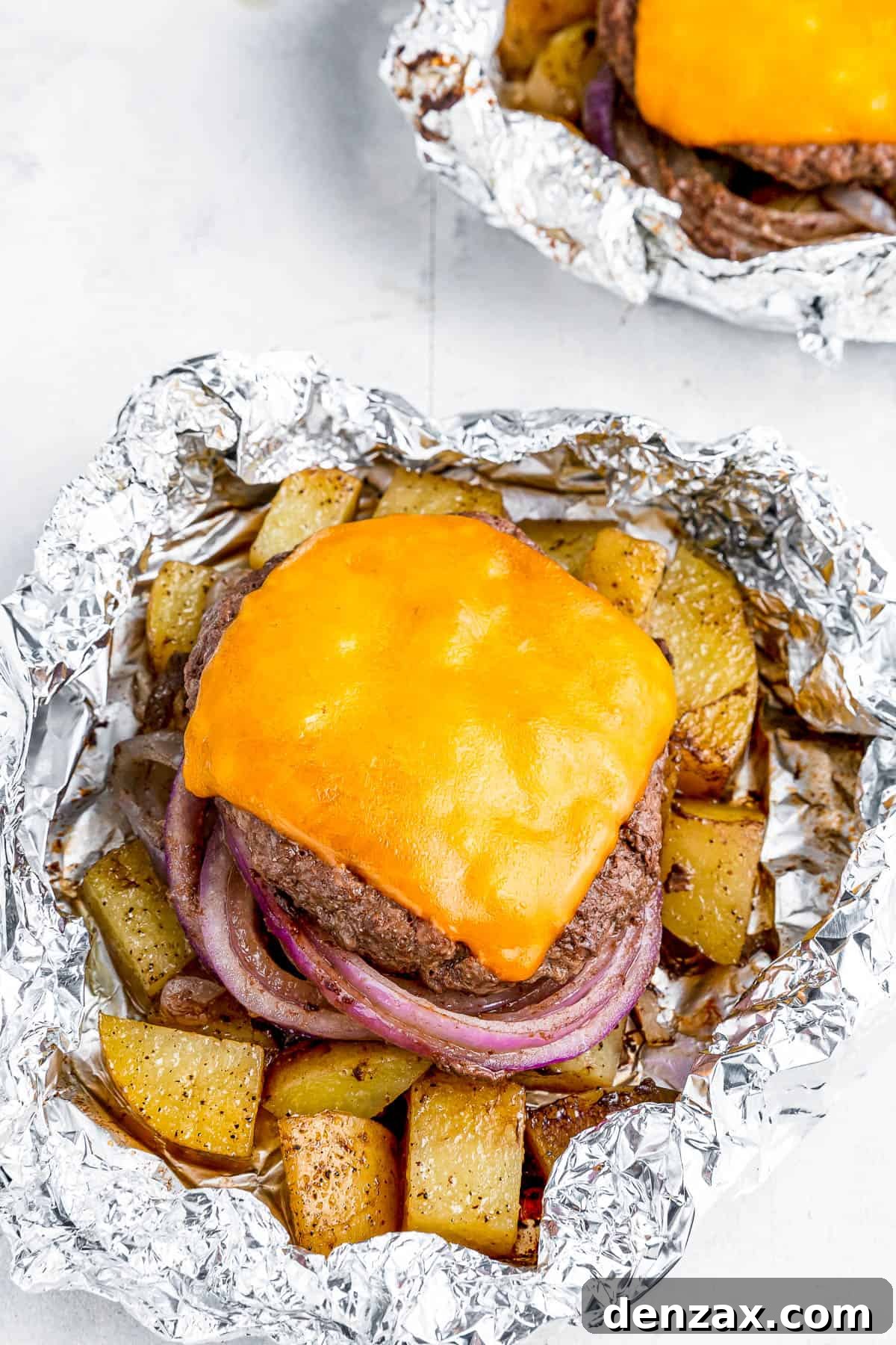 Foil-Wrapped Cheeseburgers with Roasted Veggies & Potatoes 5 Two cheeseburgers in foil with potatoes