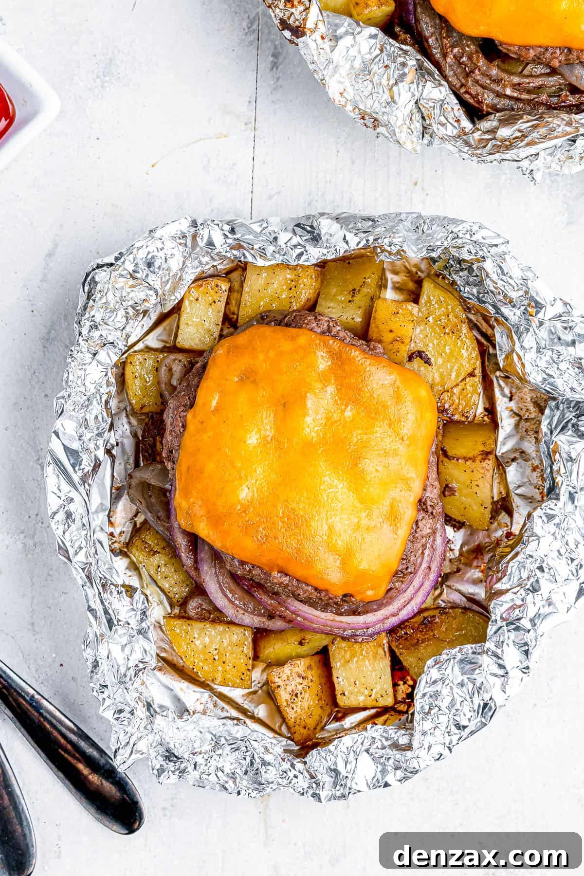 Foil-Wrapped Cheeseburgers with Roasted Veggies & Potatoes 7 Two cheeseburgers in foil with potatoes