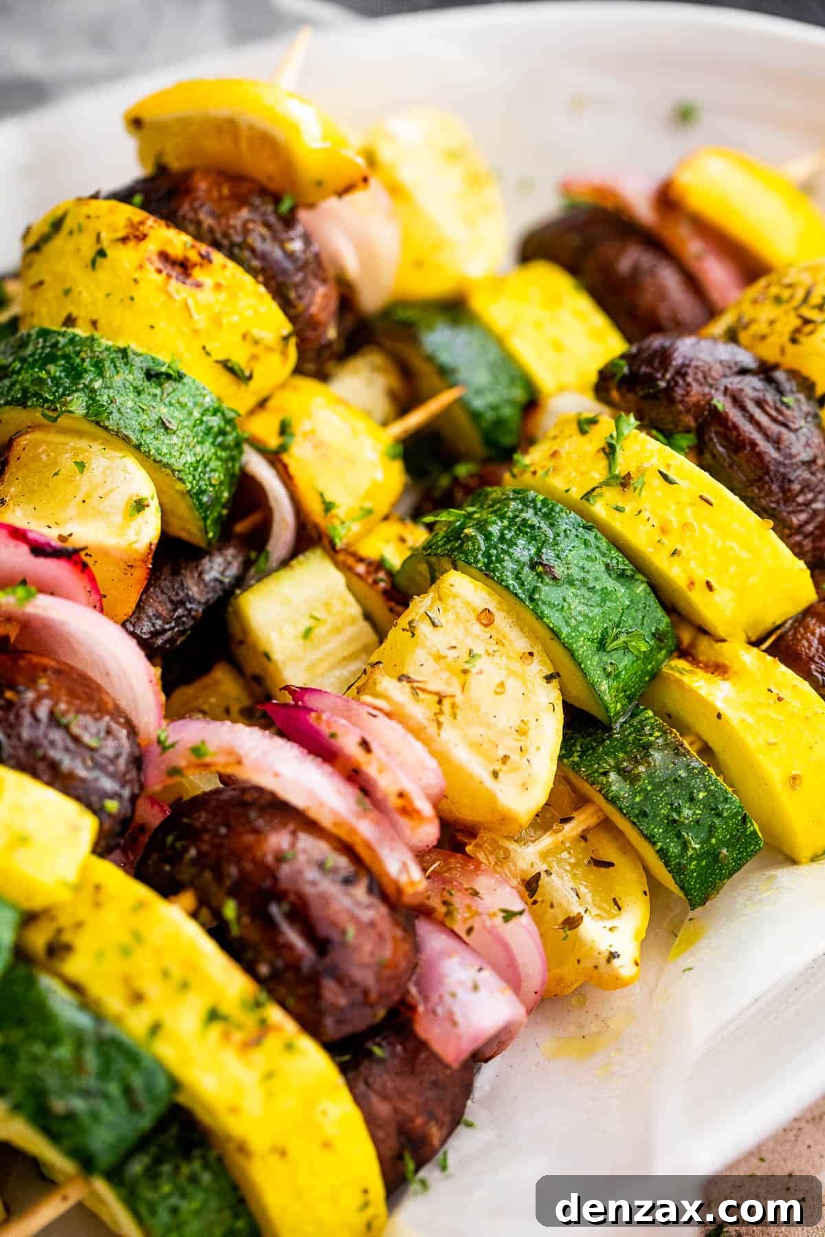 side shot of plated grilled squash skewers