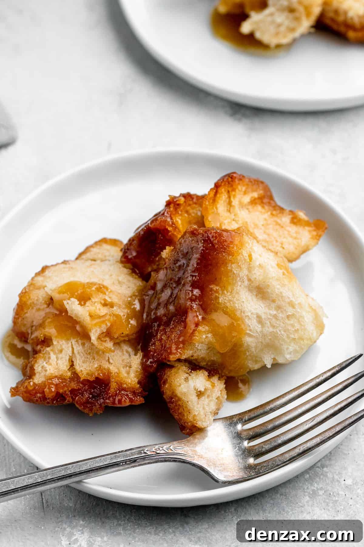 A serving of monkey bread on a dessert plate with a fork.