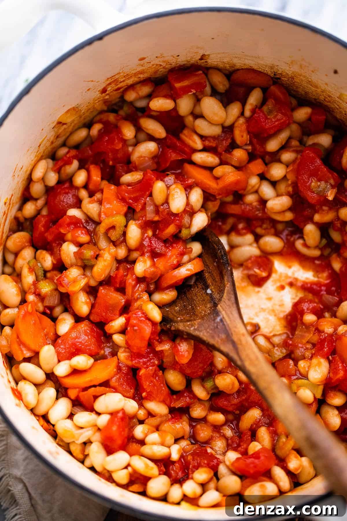 cooking beans and tomatoes in dutch oven