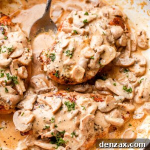 Creamy mushrooms spooned over chicken in a skillet garnished with parsley