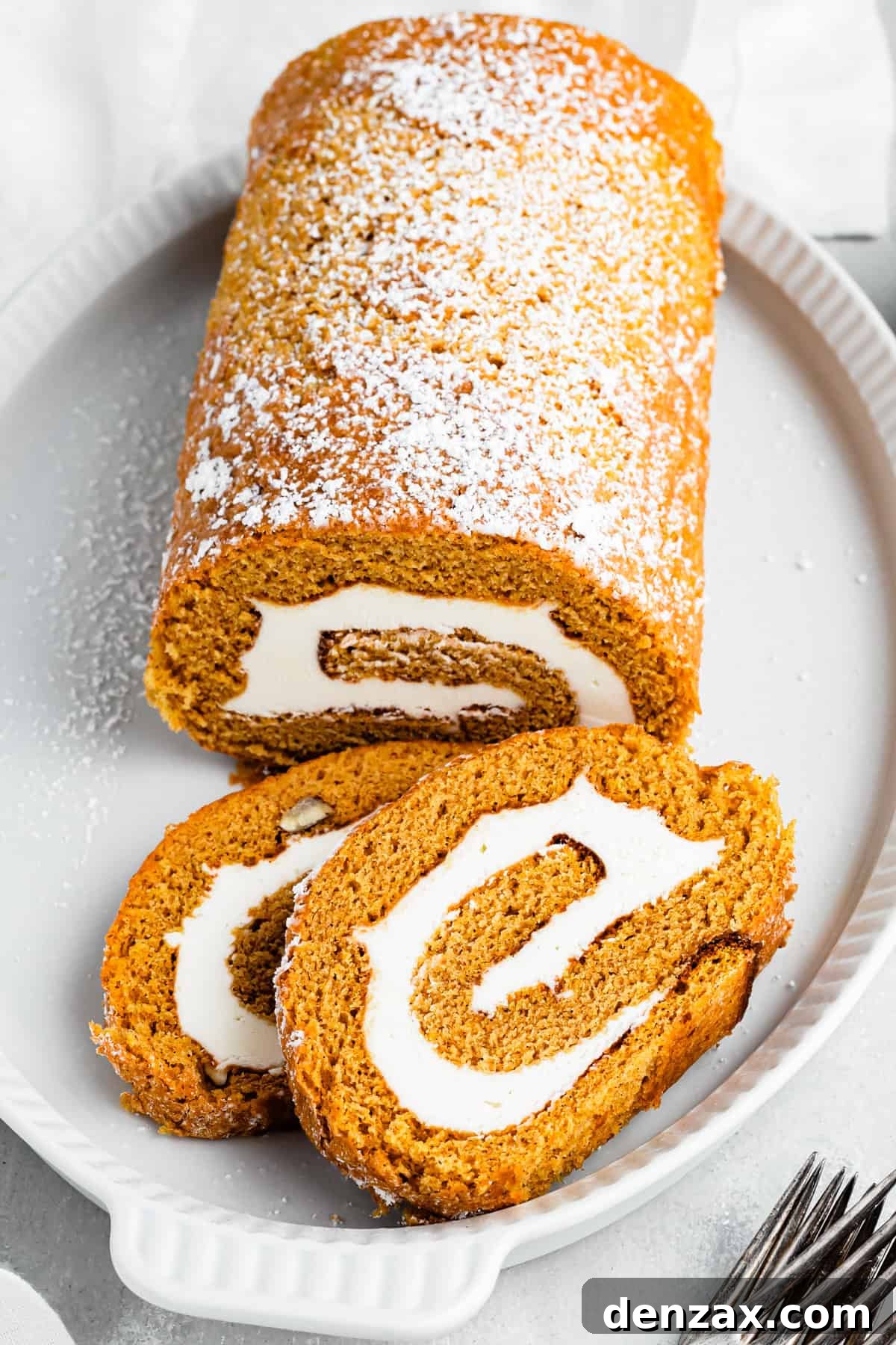A pumpkin roll served on a platter.