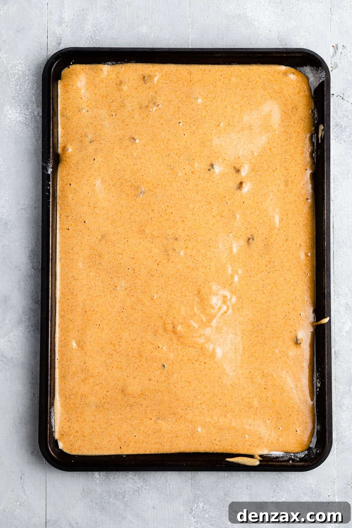 A cake batter in a baking pan.