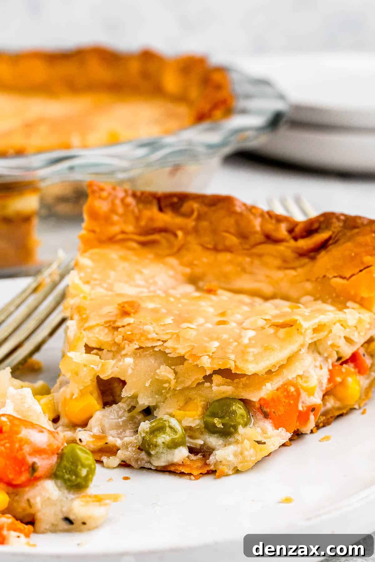 A slice of chicken pot pie on a plate