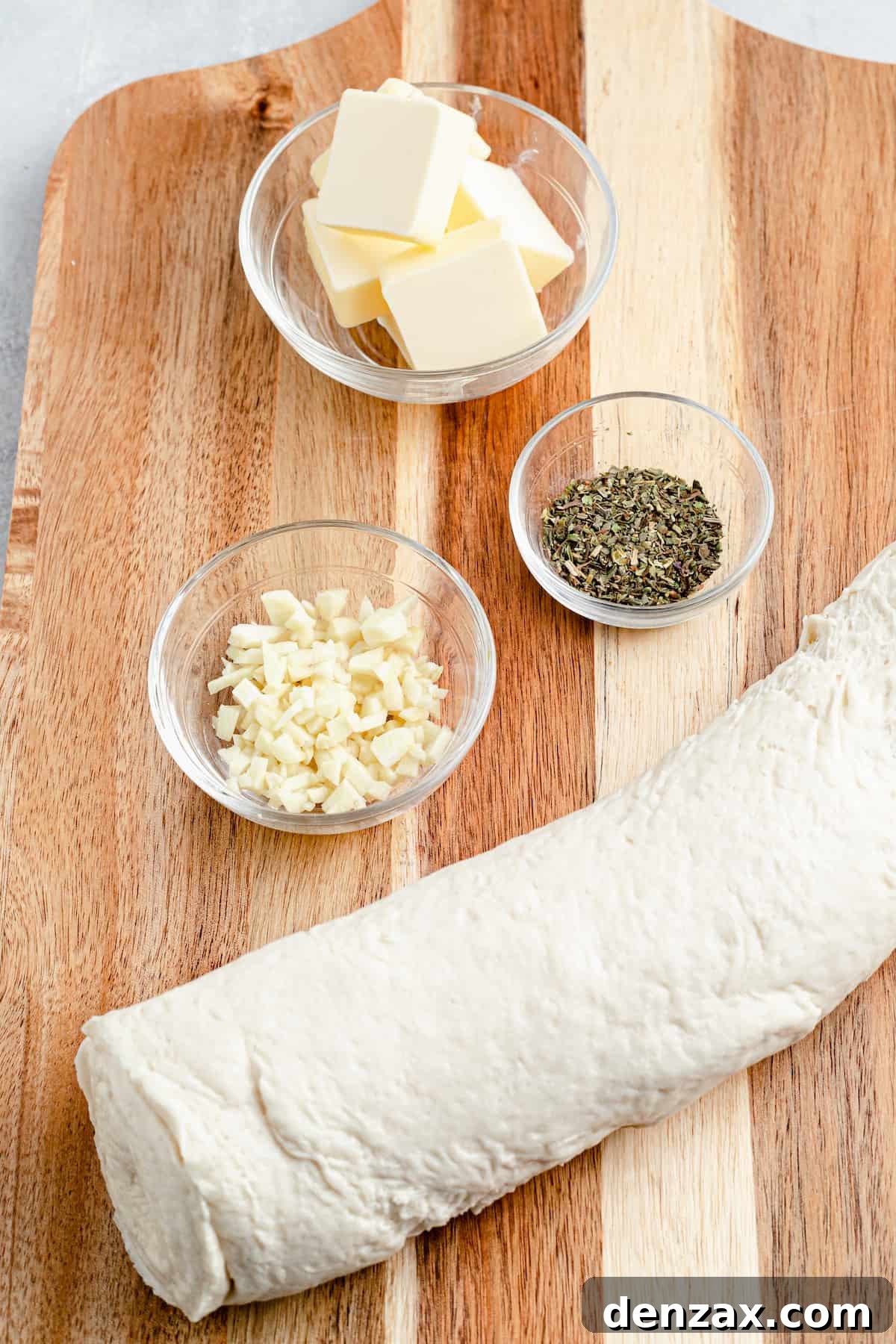Easy Homemade Garlic Knots Recipe — Soft, Buttery & Ready in 30 Minutes 4 Clockwise from top: butter, Italian seasoning, a roll of pizza dough, a dish of minced garlic.