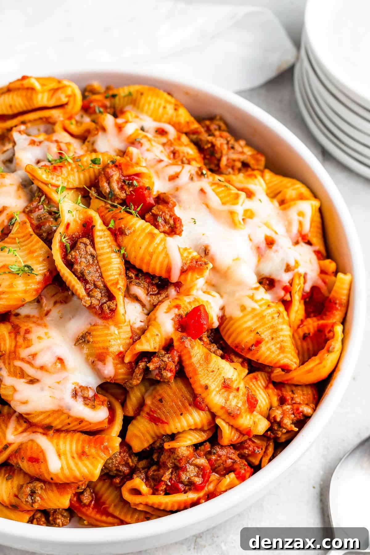 a serving of Instant Pot pasta shells and beef in tomato sauce, topped with melted mozzarella.