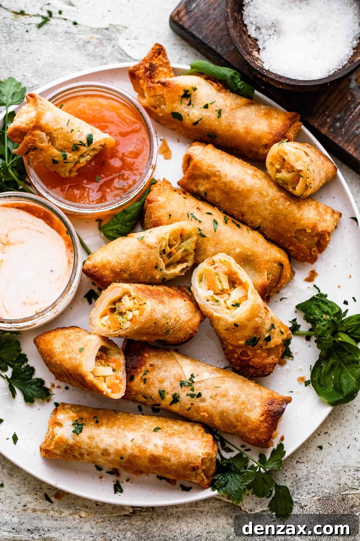 Crispy Golden Vegetable Spring Rolls Recipe 2 A plate of spring rolls with dipping sauce.